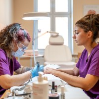 Uczennica wykonująca zabieg kosmetyczny paznokci