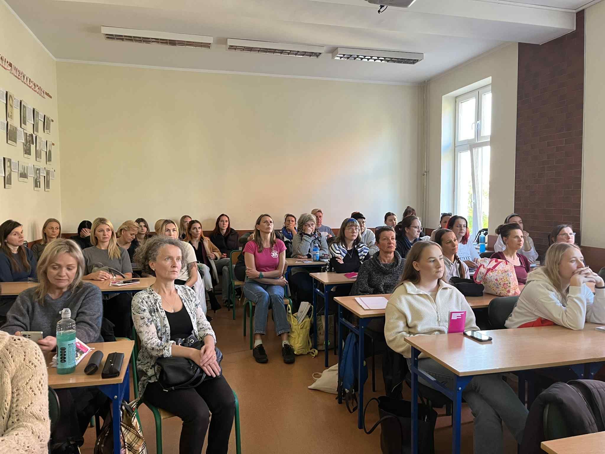 Zdjęcie grupowe uczniów na sali wykładowej.