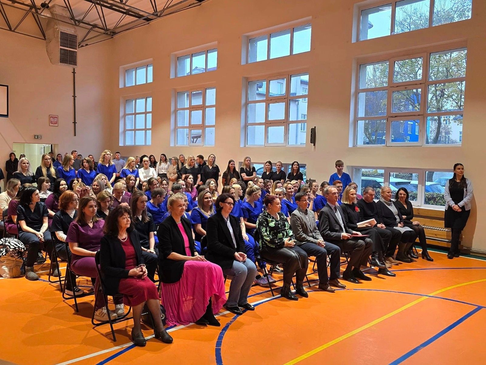 Widok na salę gimnastyczną z gośćmi.